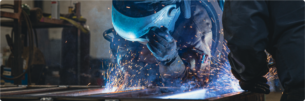 Person with welding mask, welding steel